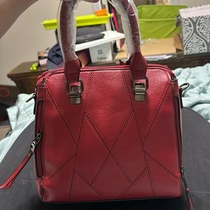 Brand new red purse with attachments. Never used.